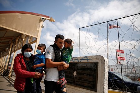 Central American migrants expelled from the U.S. under Title 42 walk towards Mexico on the Lerdo Stanton International Bridge, as seen from Ciudad Juarez