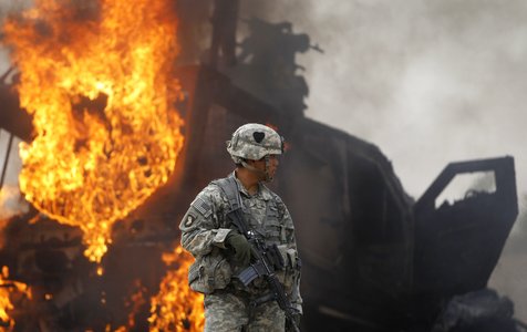 M-ATV armored vehicle burns after it struck an improvised explosive device near Combat Outpost Nolen in the Arghandab Valley