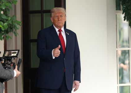 Trump gives a thumbs up at the White House  in Washington