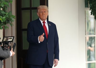 Trump gives a thumbs up at the White House  in Washington