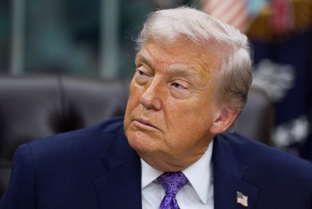 U.S. President Donald Trump signs an executive order in the Oval Office of the White House