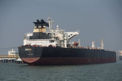 The Liberia-flagged tanker Shenlong Suezmax, loaded with Saudi Arabian crude, arrives at a port after transiting the Strait of Hormuz amid supply disruptions linked to the U.S-Israeli conflict with Iran